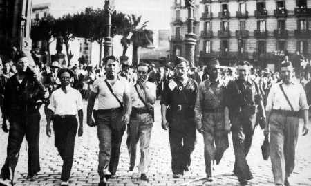 De izquierda a derecha: José Pérez Ibáñez, Severino Campos, Ricardo Sanz, Aurelio Fernández, Joan García Oliver, Gregorio Jover, Miguel García Vivancos y Augustin Souchy (Desfile en Barcelona, agosto de 1936)